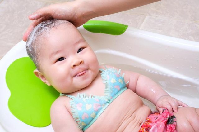 Washing baby's face with soap